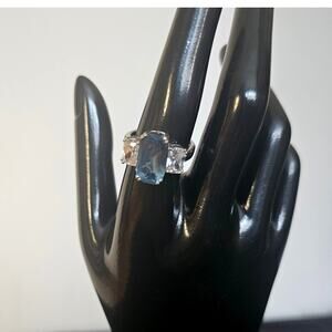 8.27CTW Emerald Cut London Blue Topaz with .14CTW Round White CZ Sterling Silver